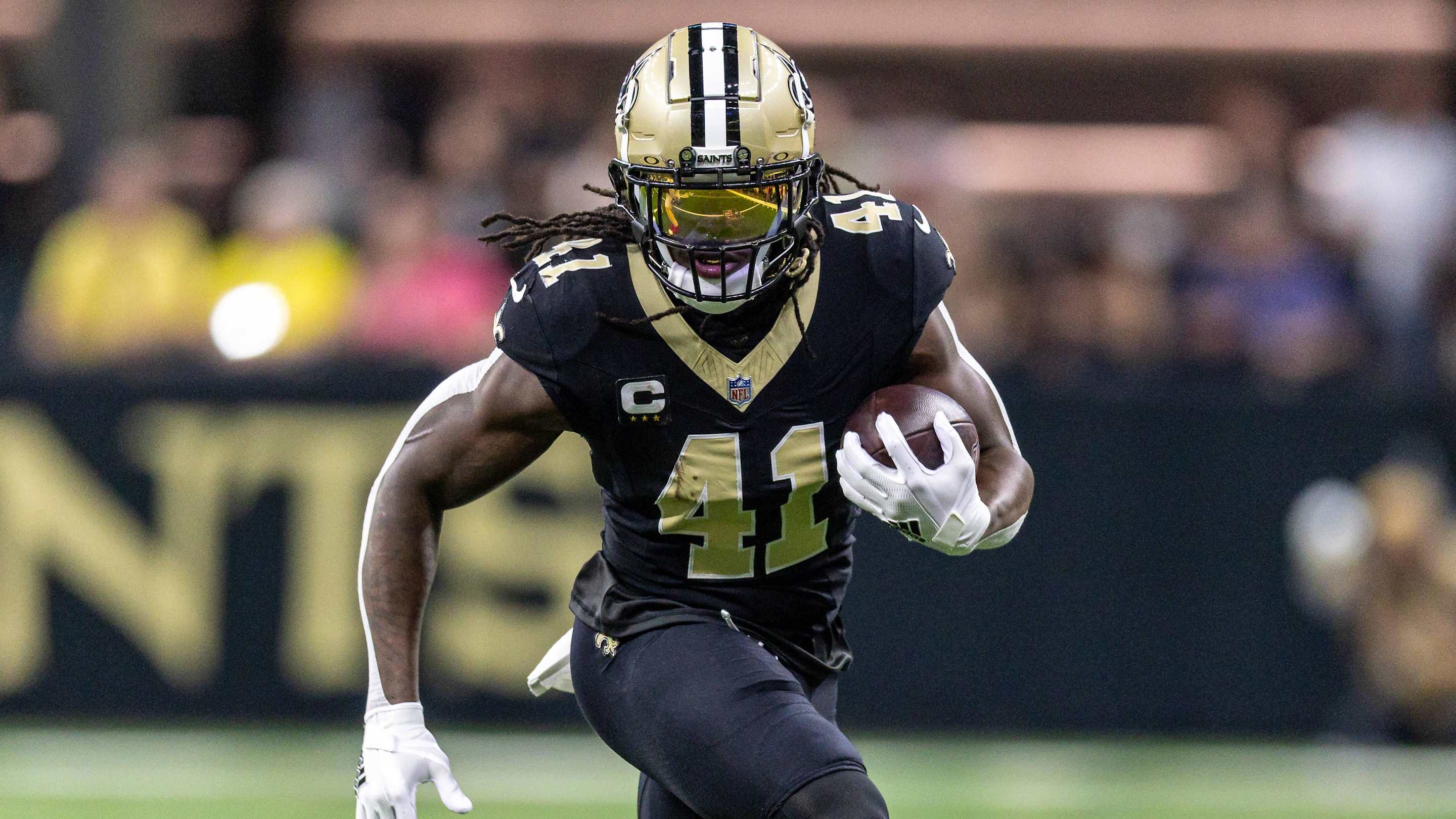 Alvin Kamara looks upfield for space.